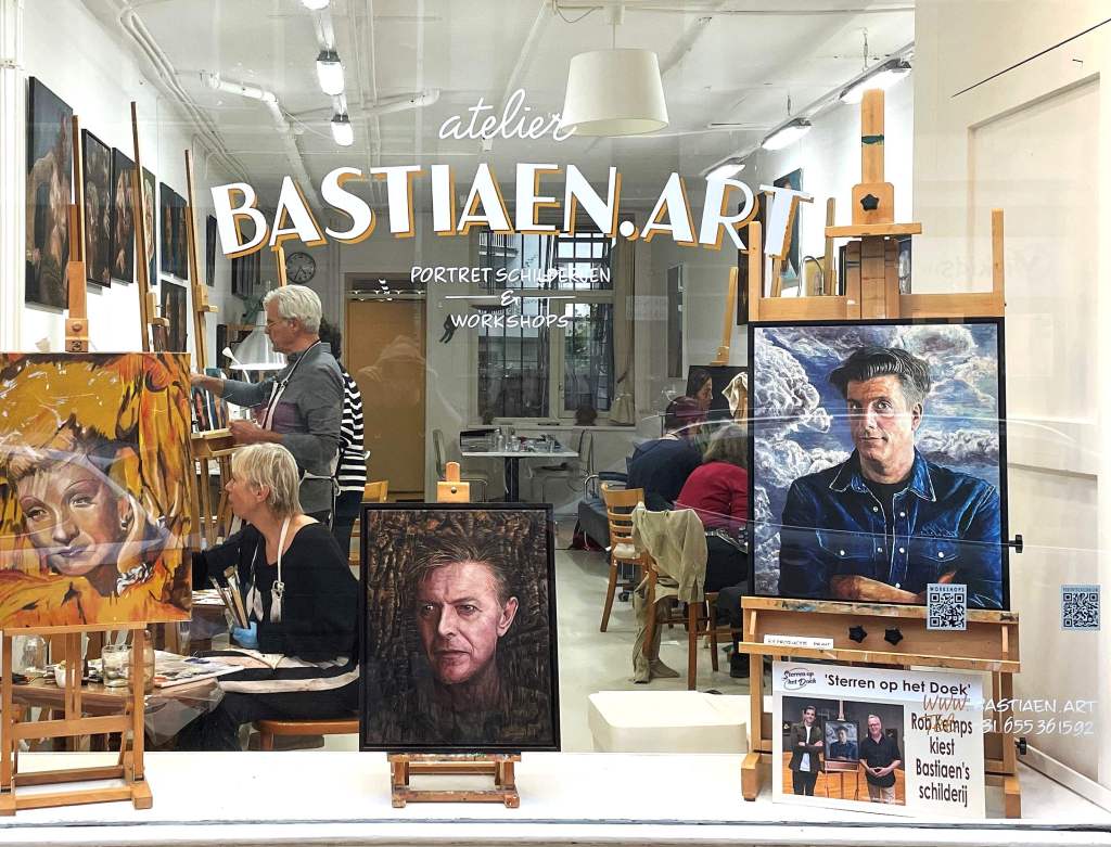 View of an Amsterdam art studio from the street with students attending an oil portrait painting workshop.